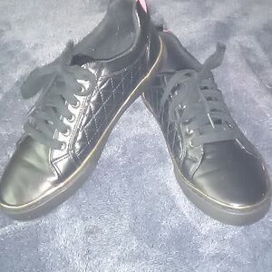 Size 11 gas black Guess shoes with gold trimming around
